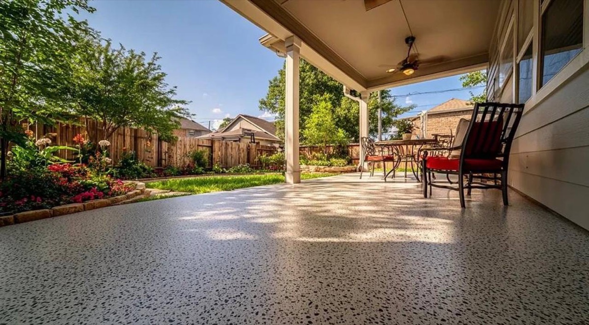 Speckled epoxy flake flooring on a covered backyard patio